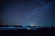 A New Moon night is a good time to star gaze. Starry night sky over the mountain city in the fog